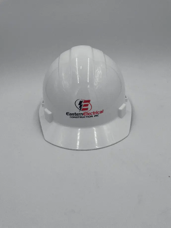 A pristine white safety helmet displaying the Eastern Electrical Construction Inc. emblem, accented by an eye-catching lightning bolt design that highlights the company's specialization in electrical services. This vital protective gear merges security with corporate branding, ensuring worker safety while reinforcing the company's presence on construction sites.
